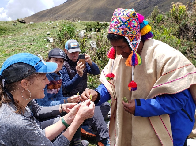 An Andean priest giving out coca leaves during a Pachamama ceremony