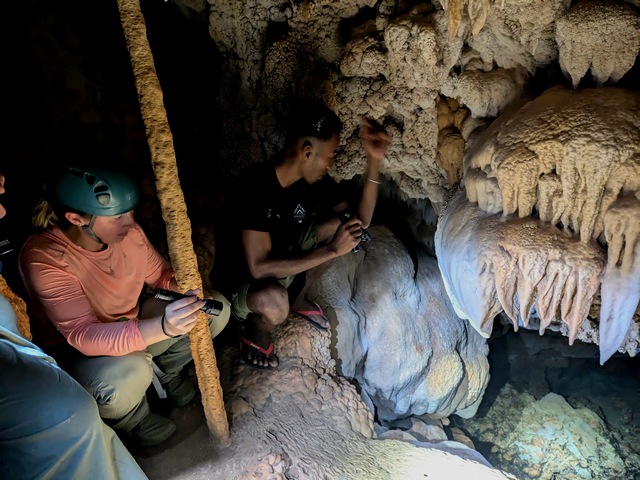 Visitors exploring the unique limestone formations of the caves at Anjajavy Reserve, Madagascar