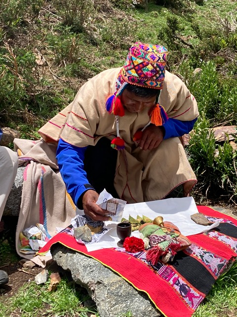 An Andean priest arranging the offerings to the Apus during a Pachamama ceremony in Peru