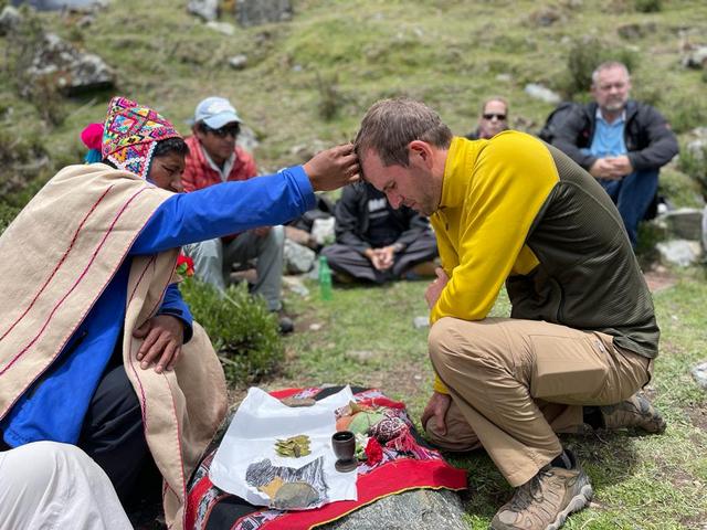 An Andean priest giving a blessing for safe travels during a Pachamama ceremony in the Salkantay region of Peru