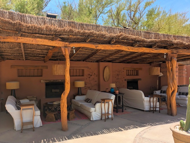 several couches and adobe-colored decor in the common area at Awasi Atacama