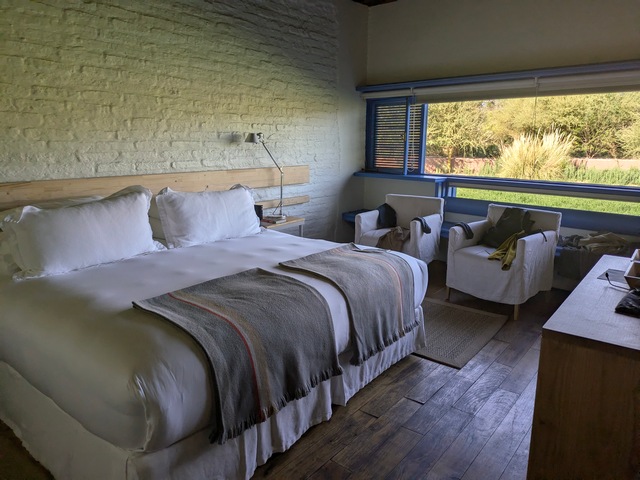 bed and chairs inside room at Explora Atacama