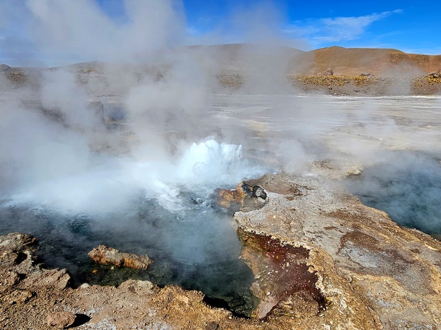 A small geyser erupting steam at El Tatio Geyser