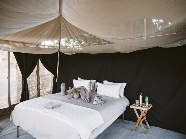 A bed inside a simple tented safari camp, Chula Island Camp, on the Lower Zambezi in Zambia