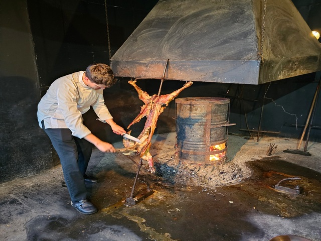 A chef prepares a traditional asado of roasted lamb in the Patagonia region of Chile