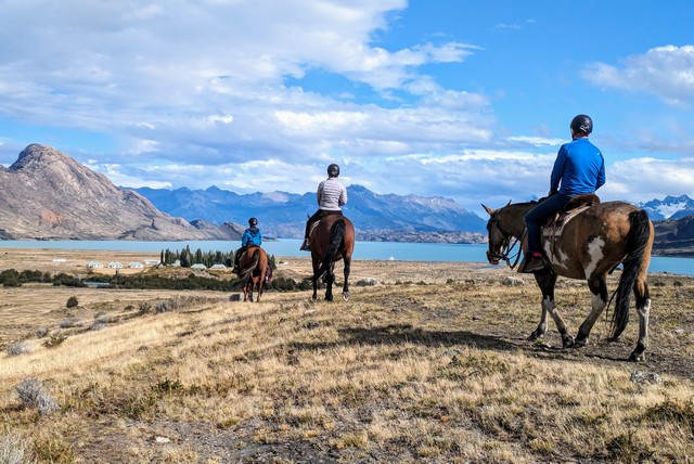 Three guests on horseback riding amidst the incredible scenery of Estancia Cristina near Los Glaciares National Park in Patagonia Argentina