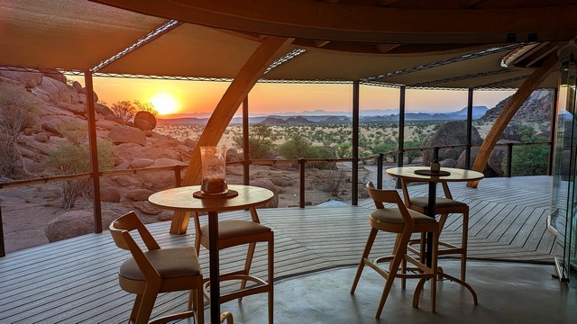 View of a colorful sunset from the dining area at Onduli Ridge Camp in Damaraland Namibia