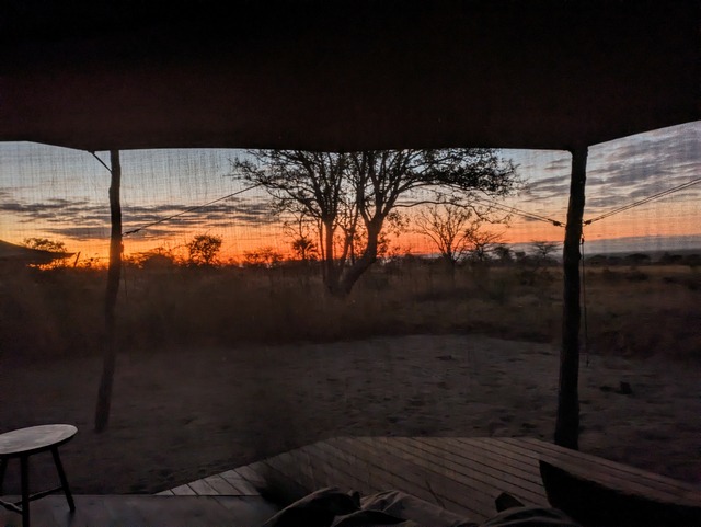 Sunrise viewed from inside a tent at the ultra-exclusive Usangu Expedition Camp in Ruaha National Park Tanzania