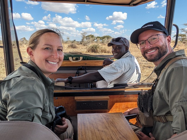 Two smiling guests with their guide on safari at Usangu Expedition Camp in Ruaha National Park Tanzania