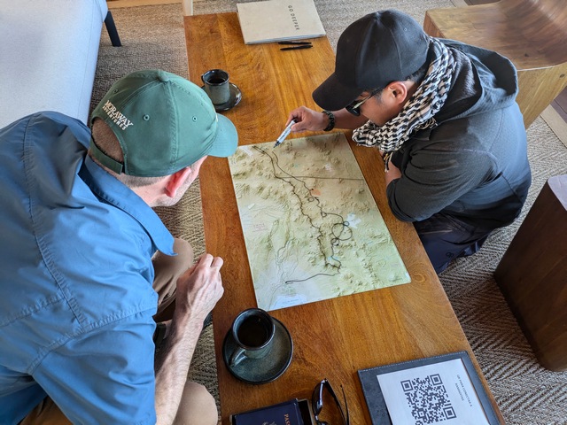 A guest at Explora Ramaditas checks the map with his private guide to prepare for the day's hike