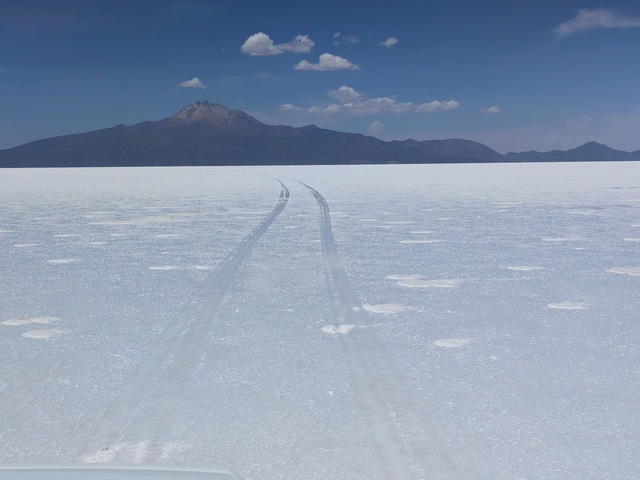 a set of tire tracks across the uyuni salt flats