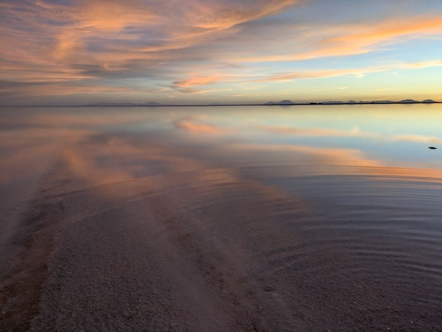 evening reflections of clouds on water at sunset at the uyuni salt flats at colchani