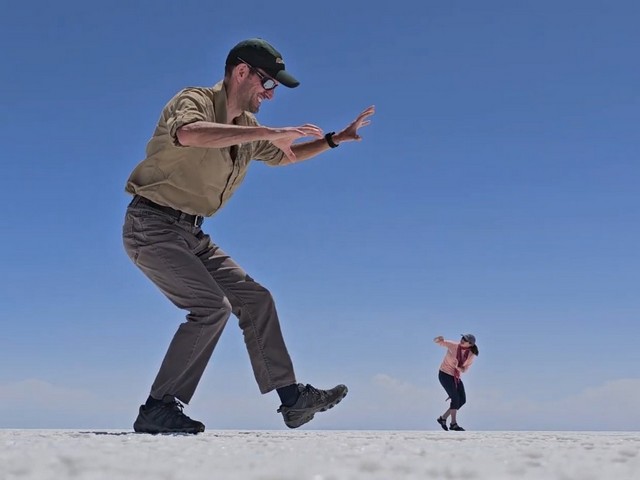 perspective photo from the uyuni salt flats of a giant chasing a woman