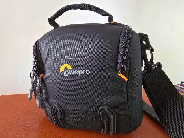 a black Lowepro brand camera bag packed for adventure travel