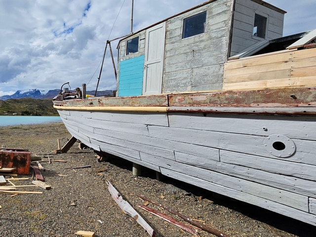 The historic Cristina boat, a small wooden boat preserved on the riverbank at Estancia Cristina