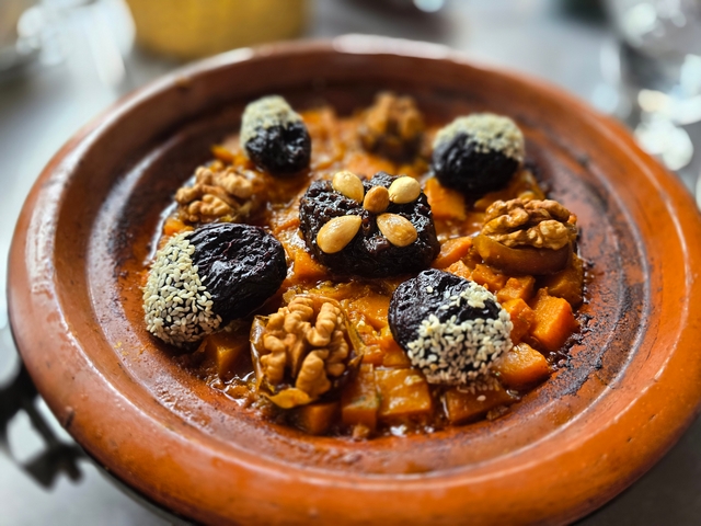 earthen dish with baked dates, walnuts, and squash in morocco