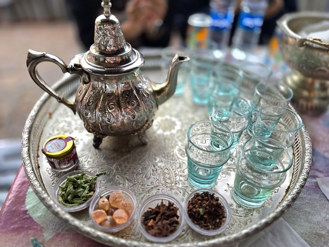 silver platter with tea pot, cups, and spices in morocco