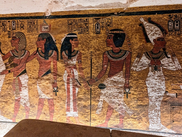 Painted mural on the north wall inside of King Tut's tomb in the Valley of the Kings in Luxor, Egypt. the images shows the Pharaoh Tutankamun followed by his soul embracing deities such as Osiris and greeting the goddess Nut.