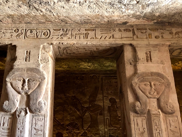 Two stone carvings representing the Egyptian goddess Hathor near the top of two columns inside the Small Temple of Hathor at Abu Simbel, Egypt.